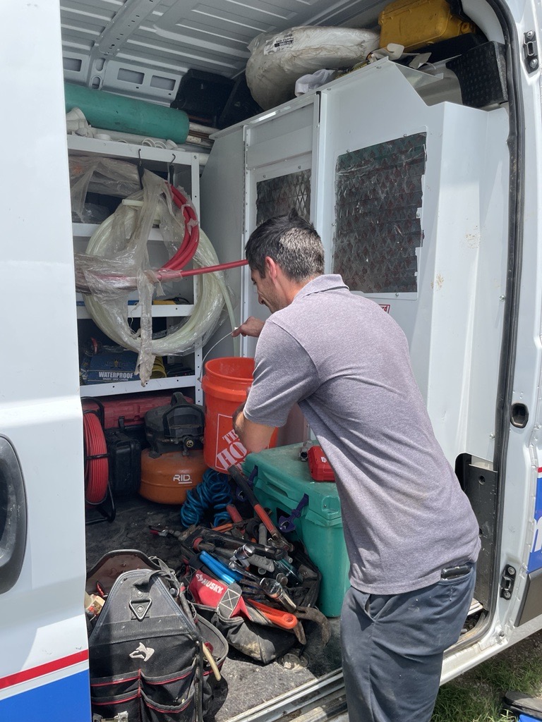 Rooter-Man of Austin technician pulling parts from the service van, real job photo